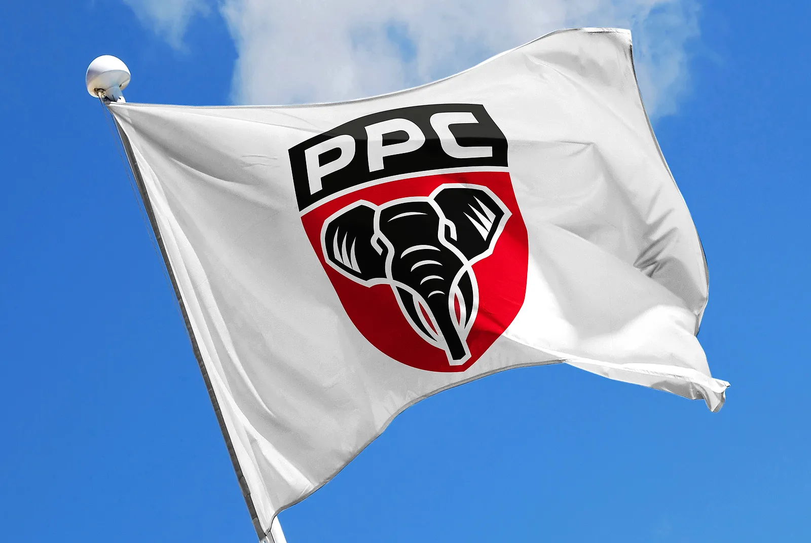 A white flag flying against a blue sky, carrying the proposed PPC shield badge with the elephant head.